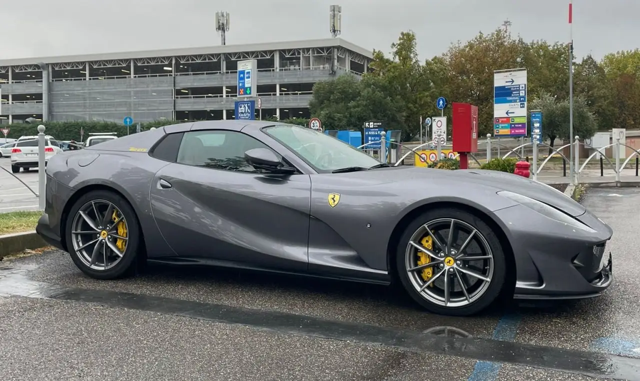 Ferrari 812 GTS 2024, rear view — Lisbon Luxury Car Rental, Lisbon. The Ferrari 812 GTS pairs a naturally aspirated V12 producing 800 hp with a folding hard…