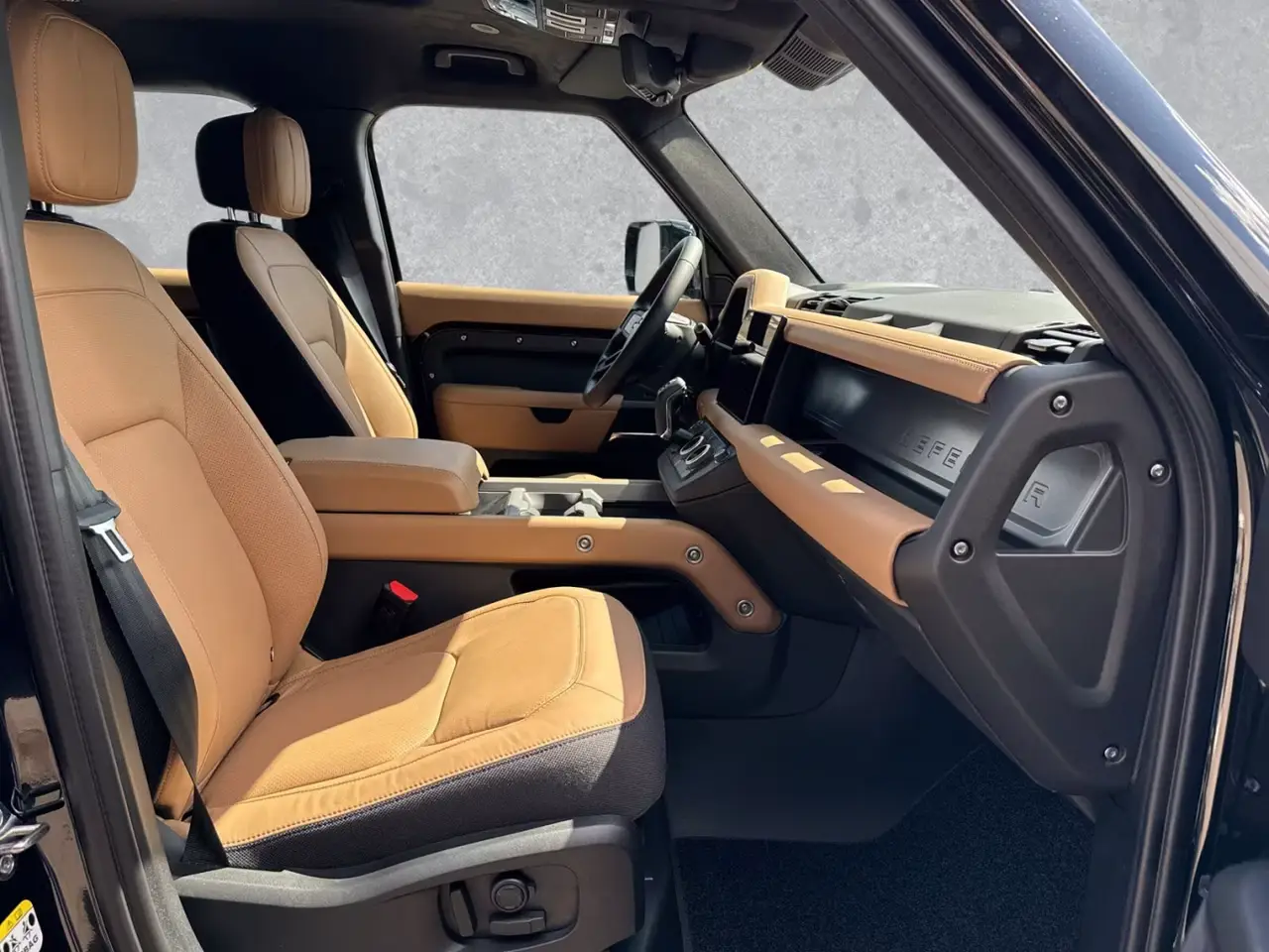 Land Rover Defender 2024, front view — Lisbon Luxury Car Rental, Lisbon. The 2024 Land Rover Defender brings 400 hp and seven seats to a fleet mostly built around…
