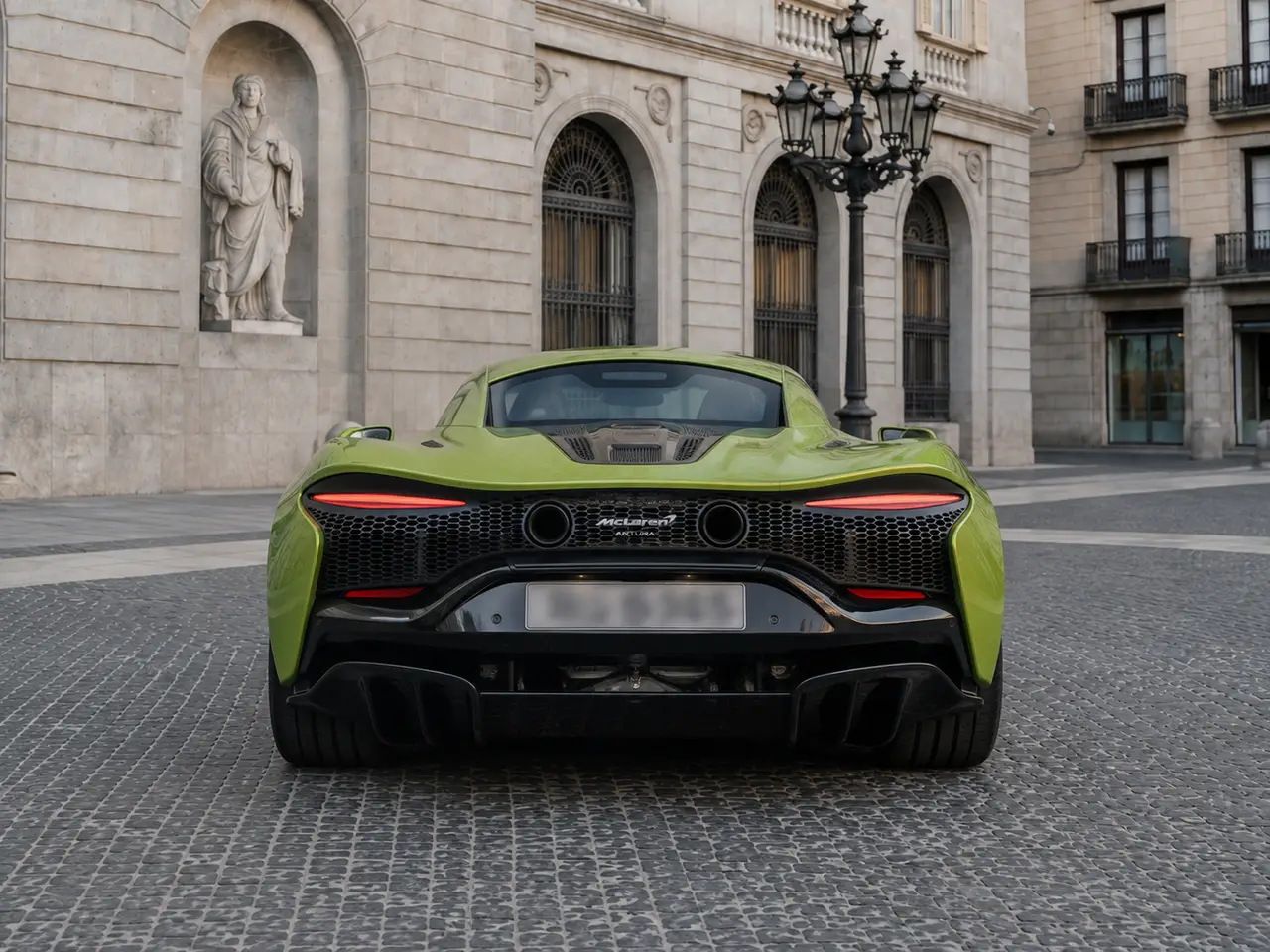McLaren Artura Spider 2024, rear view — Lisbon Luxury Car Rental, Lisbon. The 2024 McLaren Artura Spider carries a plug-in hybrid V6 producing 671 hp, delivered…