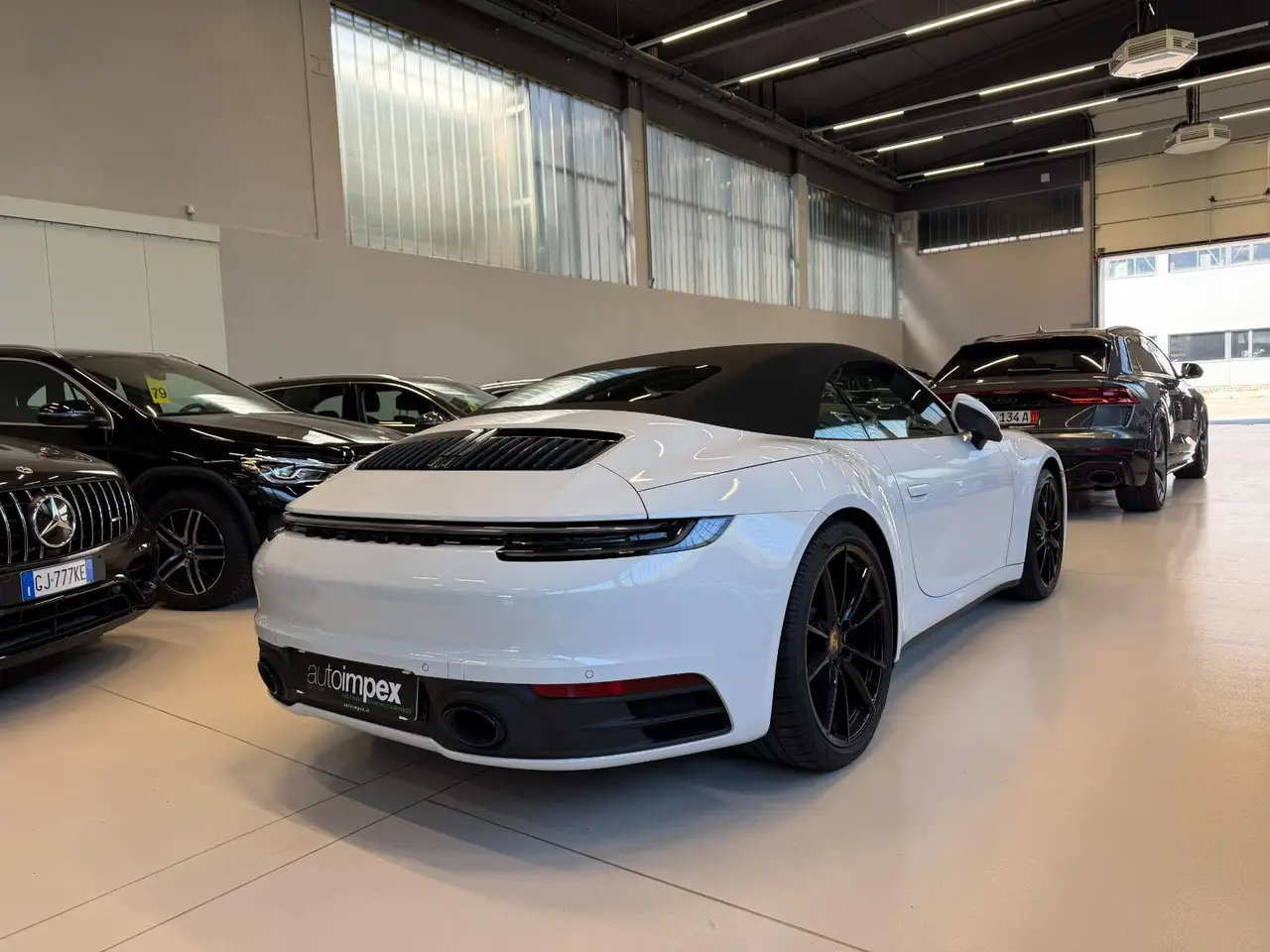 Porsche 911 Carrera S Cabrio (992) 2025, side profile — Lisbon Luxury Car Rental, Lisbon. The 2025 Porsche 911 Carrera S Cabrio (992) carries 480 hp with the composure Porsche's…