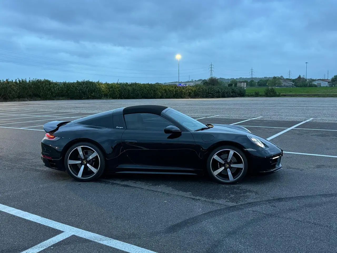 Porsche 911 Targa 2025, exterior — Lisbon Luxury Car Rental, Lisbon. The 2025 Porsche 911 Targa pairs the 911's low, deliberate stance with a retractable roof…