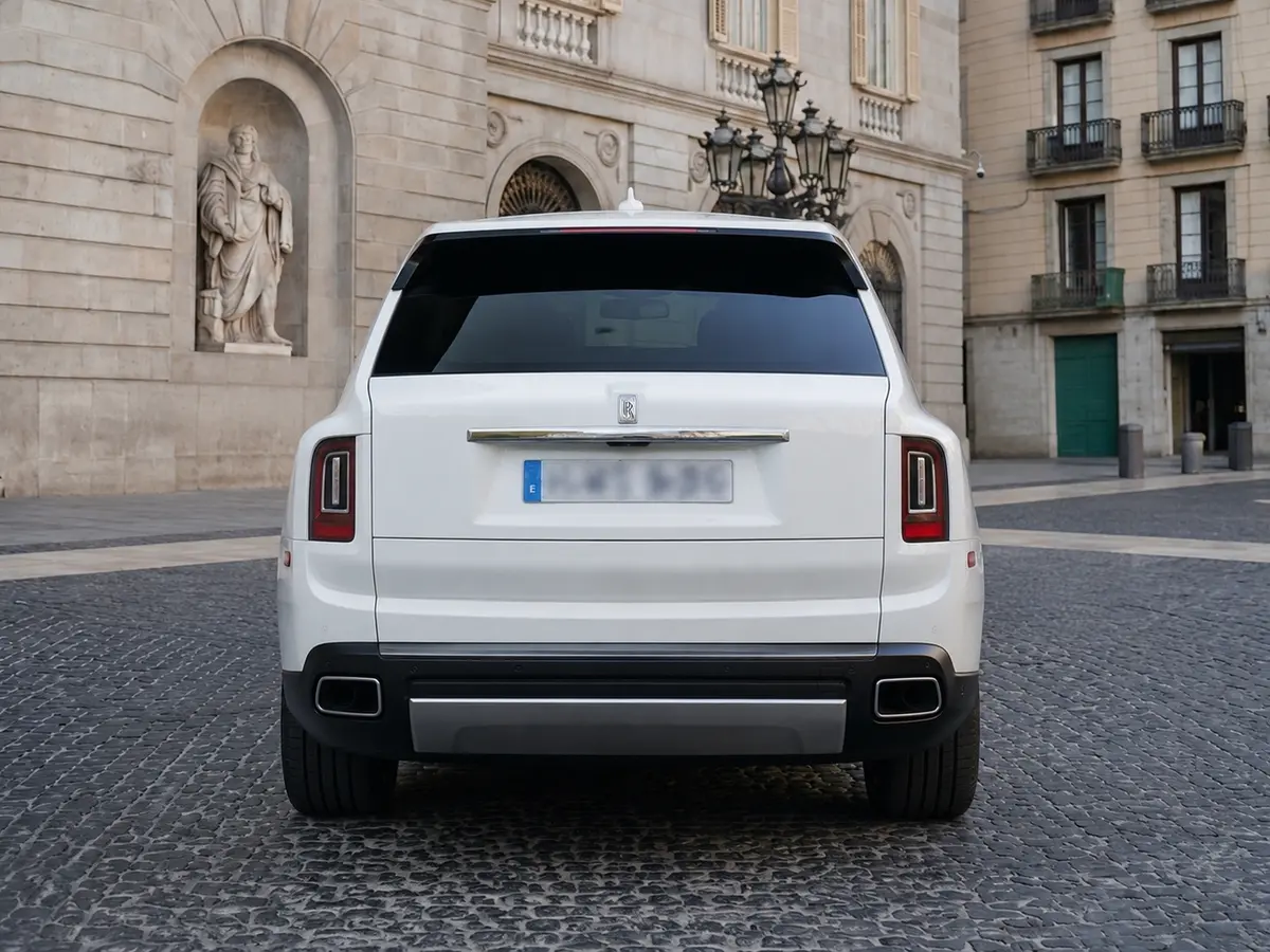 Rolls-Royce Cullinan 2022, rear view — Lisbon Luxury Car Rental, Lisbon. The Rolls-Royce Cullinan carries its size without any sense of effort. With 563 hp under…